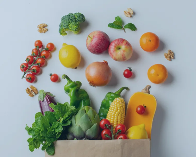 Paper shopping bag full of fruits and vegetables