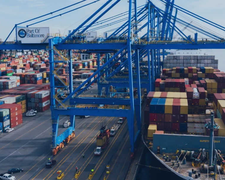 A cargo ship loaded with shipping containers, representing the L&T industry