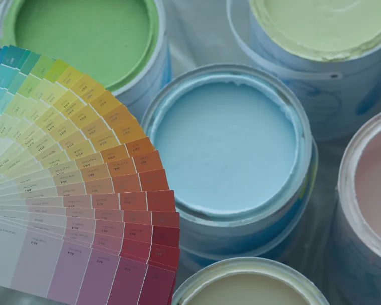 Colorful paint cans and color palette representing paints and coatings