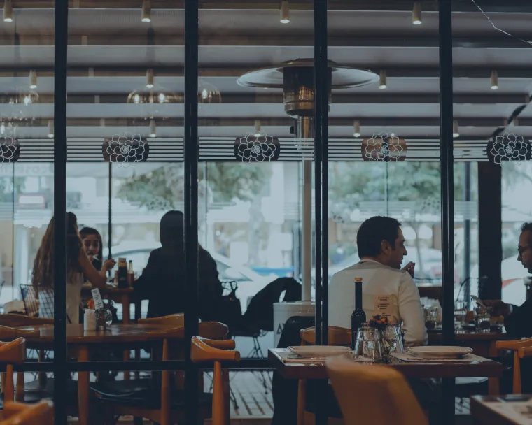 Restaurant interior with people talking representing the restaurant industry